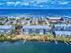 Aerial view of beachfront condos featuring private docks, lush landscaping, and ocean views at 6584 Engram Rd # 405, New Smyrna Beach, FL 32169