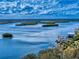 Scenic aerial view overlooking a bay with lush mangrove islands and dock at 6584 Engram Rd # 405, New Smyrna Beach, FL 32169
