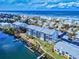 Aerial view of beachfront condos featuring private docks, lush landscaping, and ocean views at 6584 Engram Rd # 405, New Smyrna Beach, FL 32169