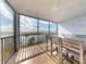 Screened-in balcony with table and chairs, offers views of the bay and sky at 6584 Engram Rd # 405, New Smyrna Beach, FL 32169