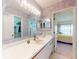 Well-lit bathroom featuring a vanity, large mirror, and a shower with sliding glass doors at 6584 Engram Rd # 405, New Smyrna Beach, FL 32169