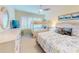 Bright bedroom with twin and full beds, floral bedding, and white furnishings at 6584 Engram Rd # 405, New Smyrna Beach, FL 32169