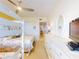Bedroom featuring a bunk bed and a full bed with floral bedding and white furnishings at 6584 Engram Rd # 405, New Smyrna Beach, FL 32169