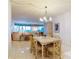 Inviting dining area with table, chairs, chandelier, and views into the living area at 6584 Engram Rd # 405, New Smyrna Beach, FL 32169