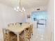Bright dining room with seating for six and a view to the kitchen at 6584 Engram Rd # 405, New Smyrna Beach, FL 32169