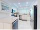 Contemporary kitchen with stainless steel appliances, white cabinetry, and island at 6584 Engram Rd # 405, New Smyrna Beach, FL 32169