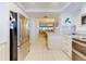 Open kitchen with stainless steel refrigerator leading into living and dining areas at 6584 Engram Rd # 405, New Smyrna Beach, FL 32169