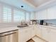 Modern kitchen with stainless steel appliances, white cabinets, and ample counter space at 6584 Engram Rd # 405, New Smyrna Beach, FL 32169