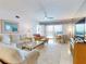 Bright living room featuring comfortable seating, ceiling fan and sliding glass doors at 6584 Engram Rd # 405, New Smyrna Beach, FL 32169