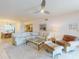 Spacious living room with comfortable seating, ceiling fan, and access to other areas of the home at 6584 Engram Rd # 405, New Smyrna Beach, FL 32169