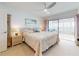 Serene main bedroom with a comfortable bed, ceiling fan, and sliding doors to the lanai at 6584 Engram Rd # 405, New Smyrna Beach, FL 32169