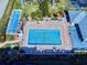 Aerial view of a community pool and shuffleboard court, surrounded by comfortable lounge seating at 6584 Engram Rd # 405, New Smyrna Beach, FL 32169