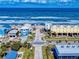 A street leading to a beautiful beach with colorful homes lining the street in a vibrant coastal community at 6584 Engram Rd # 405, New Smyrna Beach, FL 32169