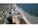 Stunning aerial view of a beachfront condo complex, nestled along a pristine shoreline with ocean views at 701 S Atlantic Ave # 11, New Smyrna Beach, FL 32169