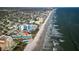 Stunning aerial view of beachfront property with ocean views and a community pool, perfect for coastal living at 701 S Atlantic Ave # 11, New Smyrna Beach, FL 32169