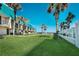 Lush grassy lawn near this beachfront building, enhanced by swaying palm trees and ocean views at 701 S Atlantic Ave # 11, New Smyrna Beach, FL 32169