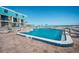 Oceanfront pool with lounge chairs and umbrellas at condo building with stunning ocean views at 701 S Atlantic Ave # 11, New Smyrna Beach, FL 32169
