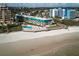 Aerial view of a beachfront condo building featuring a community pool with beach access at 701 S Atlantic Ave # 11, New Smyrna Beach, FL 32169