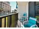 Balcony featuring blue striped chairs and a table with a black metal railing at 701 S Atlantic Ave # 11, New Smyrna Beach, FL 32169