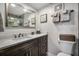 Contemporary bathroom with a white countertop, dark wood cabinets, and a walk-in shower with glass door at 701 S Atlantic Ave # 11, New Smyrna Beach, FL 32169