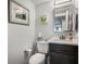 Bathroom with a dark wood vanity, white countertops and a large mirror at 701 S Atlantic Ave # 11, New Smyrna Beach, FL 32169