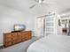Bedroom featuring a white ceiling fan and a rustic wooden dresser with a flat screen TV at 701 S Atlantic Ave # 11, New Smyrna Beach, FL 32169