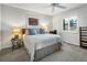 Inviting bedroom featuring a gray bedspread, bedside table and a bright window at 701 S Atlantic Ave # 11, New Smyrna Beach, FL 32169