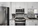 Modern kitchen featuring stainless steel appliances, granite countertops, and a mosaic tile backsplash at 701 S Atlantic Ave # 11, New Smyrna Beach, FL 32169