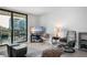 Bright living room with access to a balcony and views of the ocean and nearby buildings at 701 S Atlantic Ave # 11, New Smyrna Beach, FL 32169