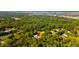 Expansive aerial view of a secluded home surrounded by lush greenery and mature trees, offering privacy at 725 Ingham Rd, New Smyrna Beach, FL 32168