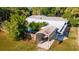 Aerial view showcasing the property with a pool, carport, and lush landscaping at 725 Ingham Rd, New Smyrna Beach, FL 32168