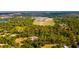 Aerial view outlining property lines surrounded by mature trees and lush greenery at 725 Ingham Rd, New Smyrna Beach, FL 32168