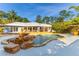 Backyard pool area showcasing a rock waterfall feature, spacious patio, and access to a covered outdoor living space at 725 Ingham Rd, New Smyrna Beach, FL 32168