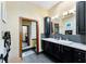 Spacious bathroom with a double sink vanity, black cabinets, and stylish decor at 725 Ingham Rd, New Smyrna Beach, FL 32168