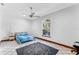 Bright bedroom features tiled floors, ceiling fan, and a cozy bed with blue striped linens at 725 Ingham Rd, New Smyrna Beach, FL 32168