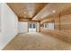 Spacious carpeted bonus room with wood ceiling, a mirror accent wall, and walk-out at 725 Ingham Rd, New Smyrna Beach, FL 32168