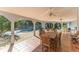 Beautiful covered patio features tile floor, ceiling fans, and dining near the pool at 725 Ingham Rd, New Smyrna Beach, FL 32168
