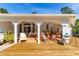 Spacious covered patio with tile flooring, ceiling fans, and access to backyard at 725 Ingham Rd, New Smyrna Beach, FL 32168