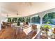 Spacious tiled covered patio with dining and comfortable seating overlooking pool and backyard at 725 Ingham Rd, New Smyrna Beach, FL 32168