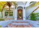 Close up showcasing a charming front door, with decorative lighting, and brick steps at 725 Ingham Rd, New Smyrna Beach, FL 32168