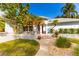 A well-manicured front entrance highlights a paved walkway and lush landscaping at 725 Ingham Rd, New Smyrna Beach, FL 32168