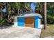 Detached blue garage with wooden door at 725 Ingham Rd, New Smyrna Beach, FL 32168