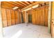 Interior view of unfinished garage space with wood framing and open door at 725 Ingham Rd, New Smyrna Beach, FL 32168