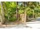 Entrance gate with secure access control, bordered by mature trees and lush greenery at 725 Ingham Rd, New Smyrna Beach, FL 32168
