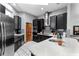 A modern kitchen is equipped with black cabinets, stainless steel appliances, and an eat-in island at 725 Ingham Rd, New Smyrna Beach, FL 32168