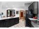 A modern kitchen with black cabinets, stainless steel appliances, and a large island, offering ample counter space at 725 Ingham Rd, New Smyrna Beach, FL 32168