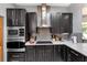 This modern kitchen boasts black cabinetry, stainless steel appliances, and ample counter space for cooking at 725 Ingham Rd, New Smyrna Beach, FL 32168