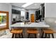 Bright kitchen features a skylight, black cabinets, stainless steel appliances and an island with seating at 725 Ingham Rd, New Smyrna Beach, FL 32168