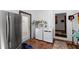 This laundry room offers a stainless steel fridge, washer and dryer, and convenient access to an outdoor area at 725 Ingham Rd, New Smyrna Beach, FL 32168
