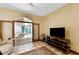 A comfy living room with sliding glass doors to a room with a massage table and exercise ball at 725 Ingham Rd, New Smyrna Beach, FL 32168